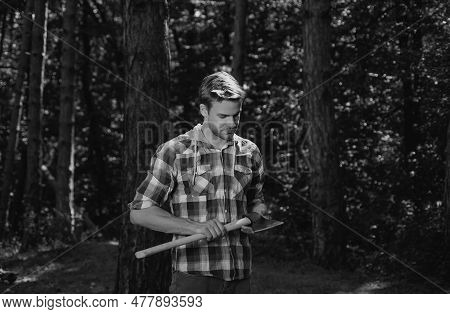 Lumberjack Standing With Axe On Forest Background. Deforestation Is A Major Cause Of Land Degradatio