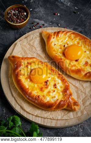 Ajarian Khachapuri, Filled With Cheese And Topped With Egg Yolk, Traditional Georgian Khachapuri On
