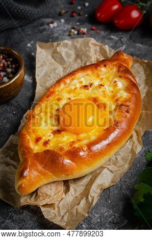 Ajarian Khachapuri, Filled With Cheese And Topped With Egg Yolk, Traditional Georgian Khachapuri On