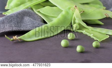 Organic Green Sugar Snap Peas Ready To Eat On Cement Background. Macro Slide.
