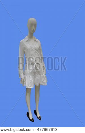 Full Length Image Of A Female Display Mannequin Wearing Trendy White Shirtdress With Belt Isolated O