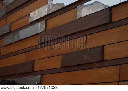 Building Wall. Finishing With Decorative Brown Wood And Mirror Panels. Beautiful Abstract Wooden Bac