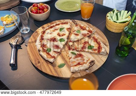 Pizza On A Table With Varius Elements