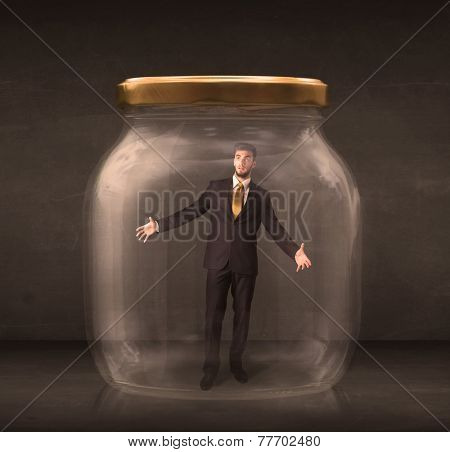 Businessman shut into a glass jar concept on background