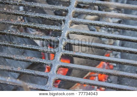 Glowing coals under the grid.