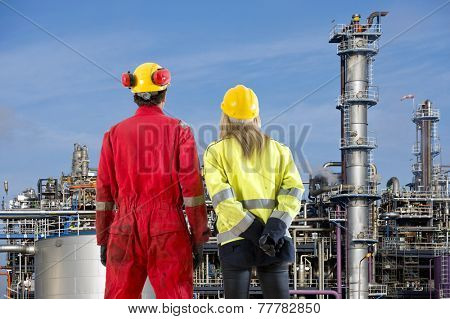 Two petrochemical engineers looking at a new cracking facility for hydrocarbon products used in polyurethane compounds