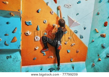 Woman Climbing Up On Practice Wall