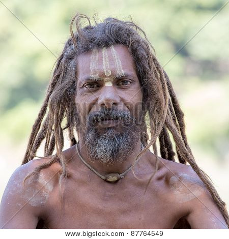 Sadhu, Holy Man Sits On The Ghat Along The Ganges River. Rishikesh, India