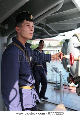 SEVASTOPOL, CRIMEA, UKRAINE - AUGUST 17, 2012: Seamen at the torpedo tubes on the Russian frigate 