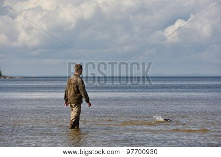 VALAAM ISLAND, RUSSIA - JULY 29, 2015: Vyacheslav Alekseev releases the Ladoga ringed seal into the lake Ladoga. Animal was cured in the Center of study and conservation of marine mammals