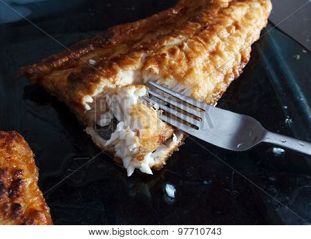 A Piece Of Fish In Batter Served With French Fried Potato Chips, Lemon And A Lettuce, Rocket, Cucumb