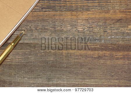 Notepad With Gold Fountain Pen On The Old Wood Table