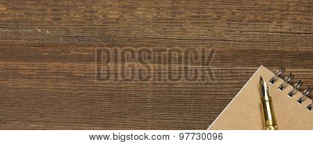 Notepad With Gold Fountain Pen On The Old Wood Table
