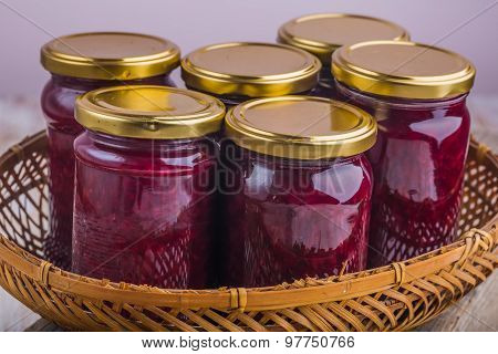Jars Of Jam With Cherries In Basket