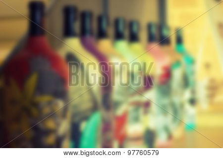 Colorful bottles of wine blurred background