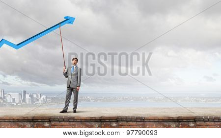 Young businessman caught increasing graph with lead