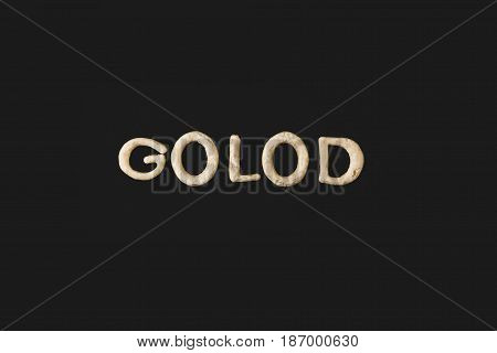 Top View Of Word Golod Made From Cookie Dough Isolated On Black