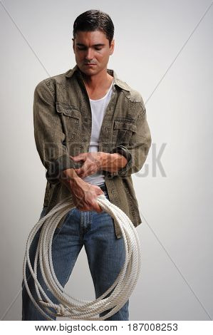 The darling cowboy is holding on to his lasso.