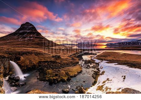Spring Sunrise Over The Famous Kirkjufellsfoss Waterfall With Kirkjufell Mountain In The Background