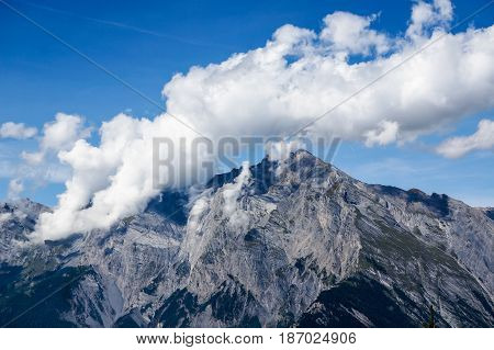 White cloud above the mountain part of the Alps in Nendaz, Switzerland.
