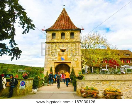 Schaffhausen, Switzerland - May 01, 2017: The view on castle Schloss Laufen patio, tower. Castle on Rhainfall waterfall biggest in Europe. Swiss holidays vacations famous sightseeing tours