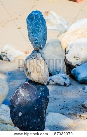 Stacked rocks on seashore in the sand