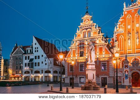 Riga, Latvia - July 1, 2016: Schwabe House And House Of The Blackheads At Town Hall Square, Ancient Historical Landmark And Popular Touristic Showplace In Summer Evening. Night Illuminations