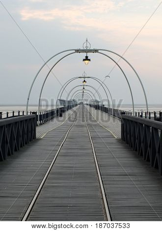 southport pier at sunset with walkway and tram lines