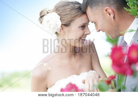 Bride and groom exchanging vows and wedding ring