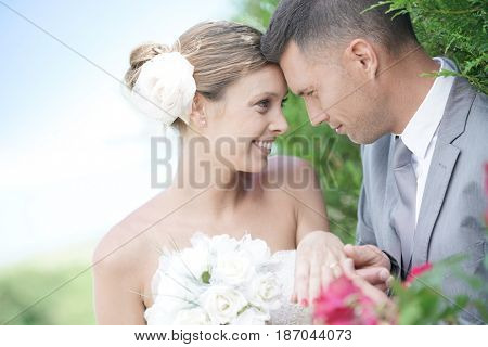 Bride and groom exchanging vows and wedding ring