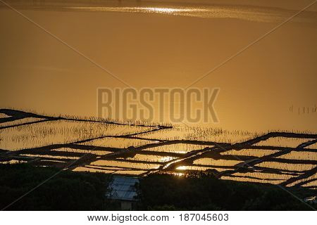 Vintage saltmine at sunset with orange water