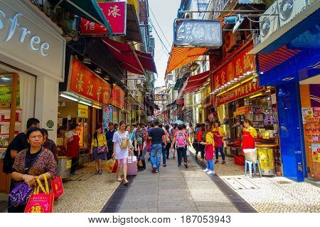 MACAU, CHINA- MAY 11, 2017: An unidentified people walking in the streets of Macau, located near Ruins of St. Paul's, Macau.