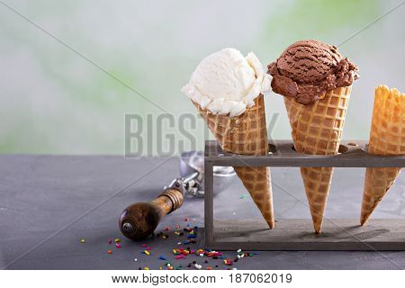 Variety of ice cream scoops in cones with chocolate and vanilla