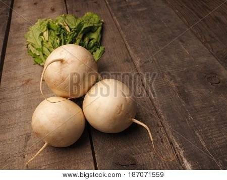 May turnip on a rustic wooden table with space for text