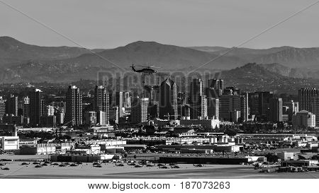 A military helicopter flies over the city of San Diego. The photo was taken from the Cabrillo national monument area.