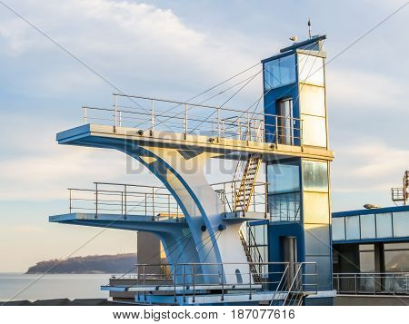 Diving tower and cloudy sky as background