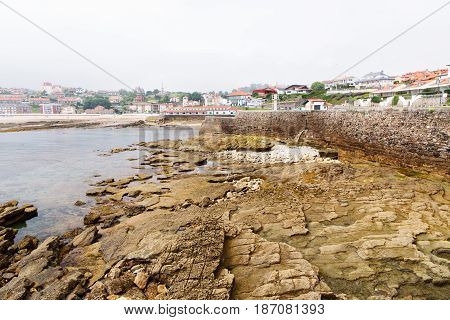View of Comillas city in northern Spain. A look in foggy day from the ocean during an outflow