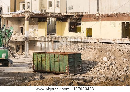 Excavator in front of a demolition site