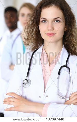 Happy doctor woman with medical staff at the hospital.