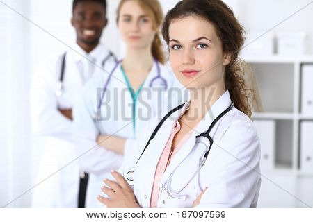 Happy doctor woman with medical staff at the hospital.