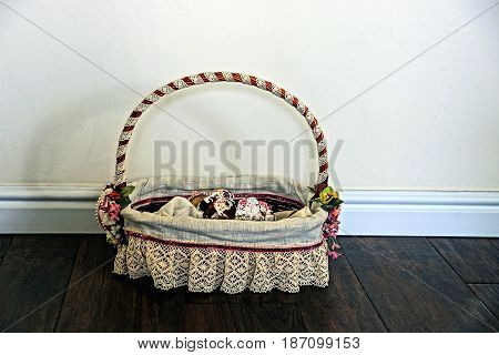 Festive basket with patties on the floor near the wall