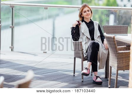 Woman Sit Near The Table Hold Her Glasses