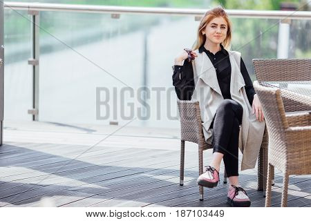 Woman Sit Near The Table Hold Her Glasses