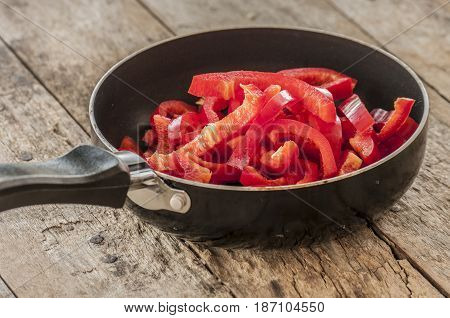 Cut red peppers prepared food.close up in pan