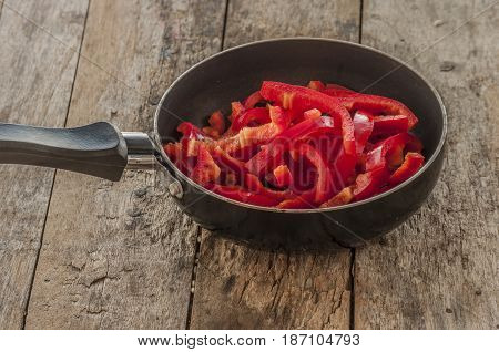 Cut red peppers prepared food.close up in pan