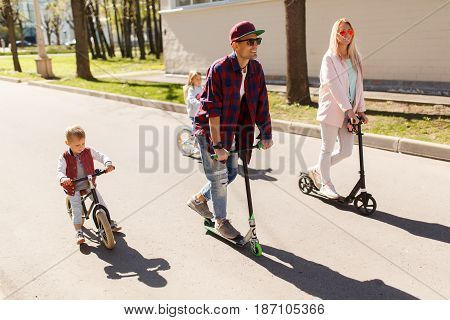 Young family on bicycles at path in park