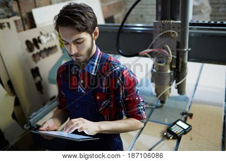 Engineer with touchpad browsing in the net