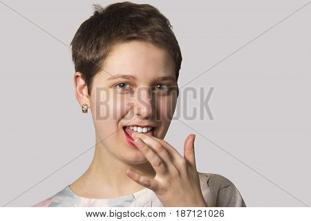 Woman licking her fingers and tasting something. path clipping for easy operation designer. isolated on neutral gray background