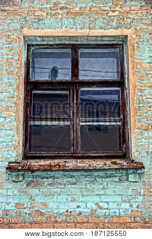 old window on the brick wall of building