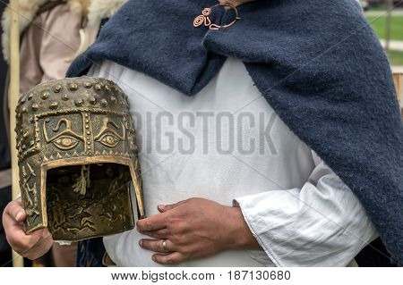 Dacian combat helmet and specific textile coat at an antique arms exhibition.